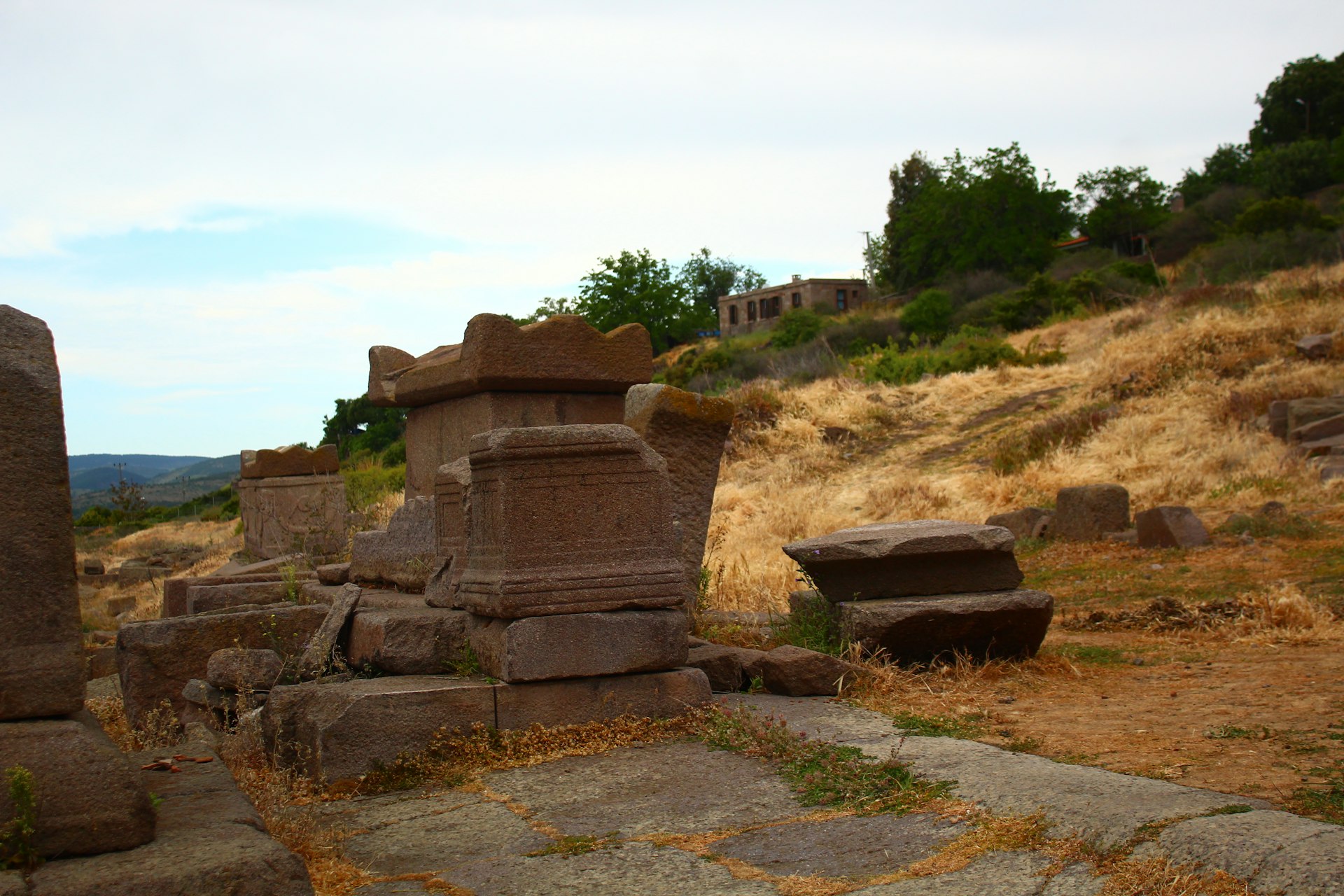 Ancient stone ruins sit on a hillside.